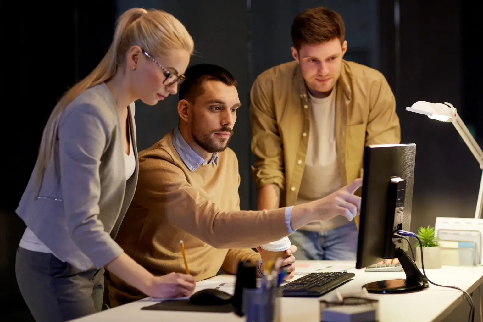 business team with computer working late at office