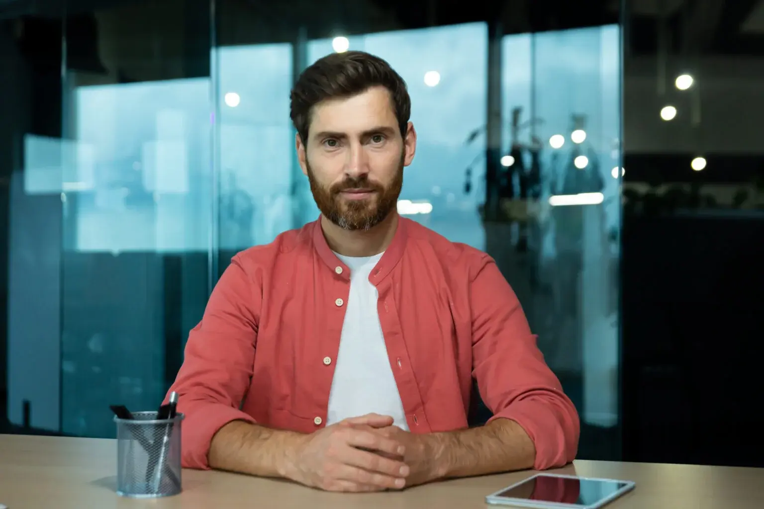 online video chat remote business meeting businessman red shirt looking seriously thinking focused into camera listening interlocutor webcam view inside office 1536x1024 1